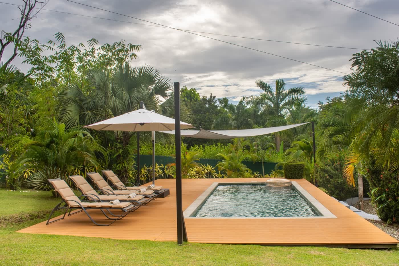 Clean pool deck beside a screen enclosure